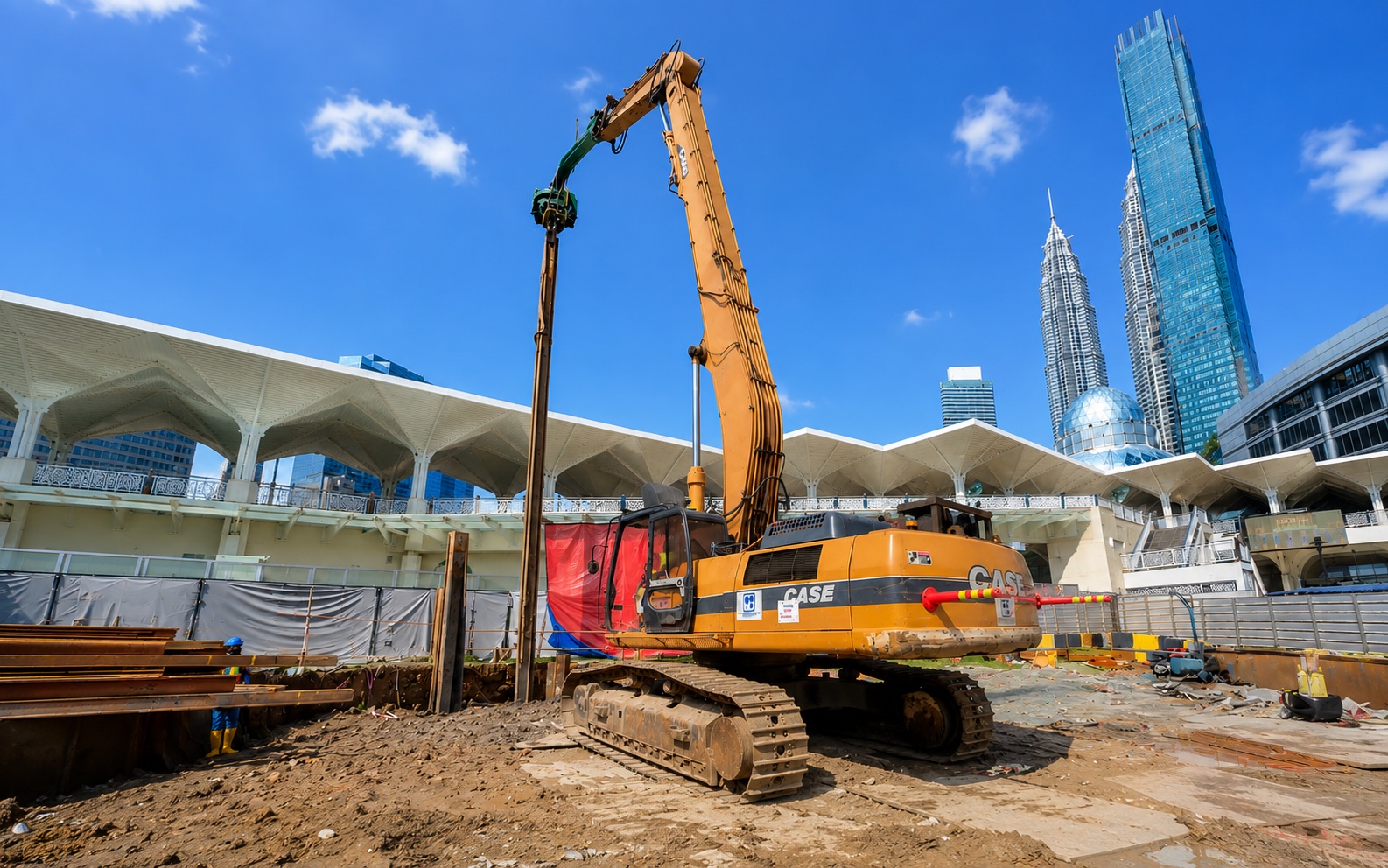 Long-reach piling rig driving sheet piles on a Kuala Lumpur city-centre site