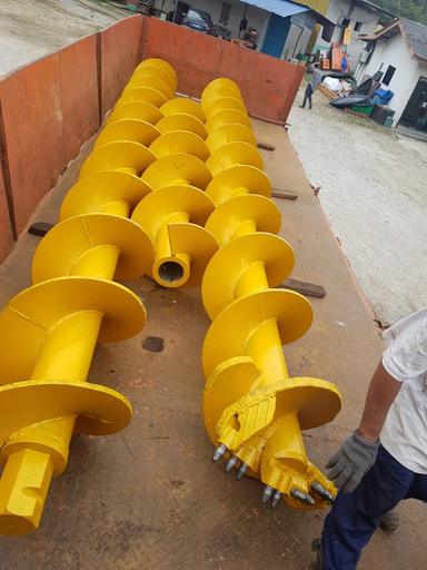 Preboring augers on the yard floor